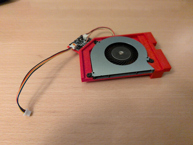 The fan and PWM controller on their 3D printed mounting bracket, outside the laptop.